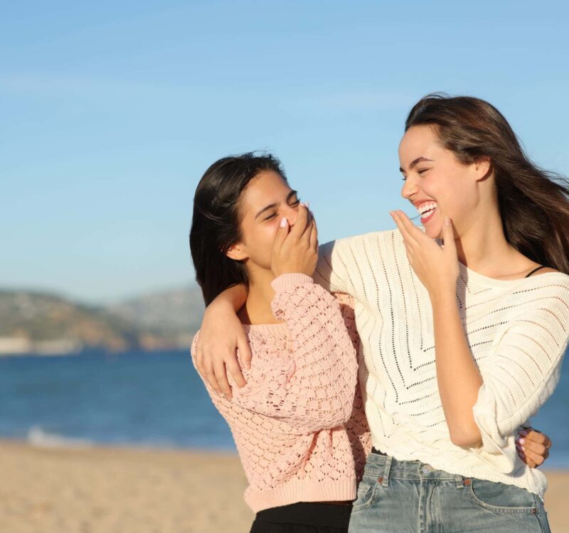 Happy,Best,Friends,Talking,And,Laughing,Walking,On,The,Beach