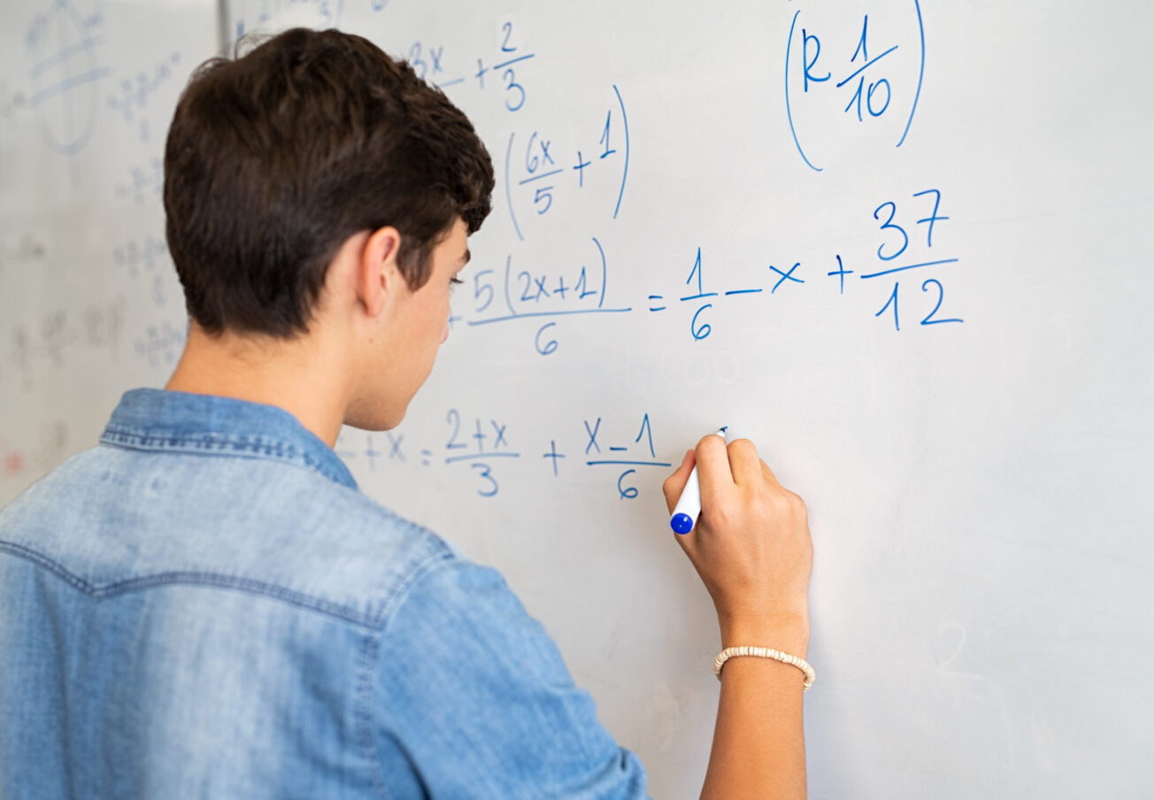 Back,View,Of,High,School,Student,Solving,Math,Problem,On