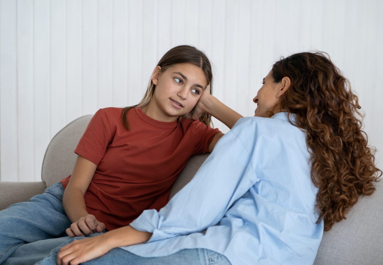 Relaxed,Optimistic,Woman,And,School,Age,Girl,Talking,And,Sharing