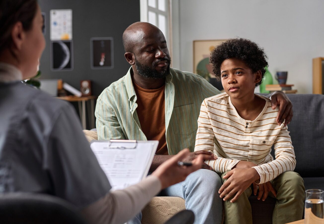 Portrait,Of,Teenage,Boy,Listening,To,Psychologist,During,Family,Therapy