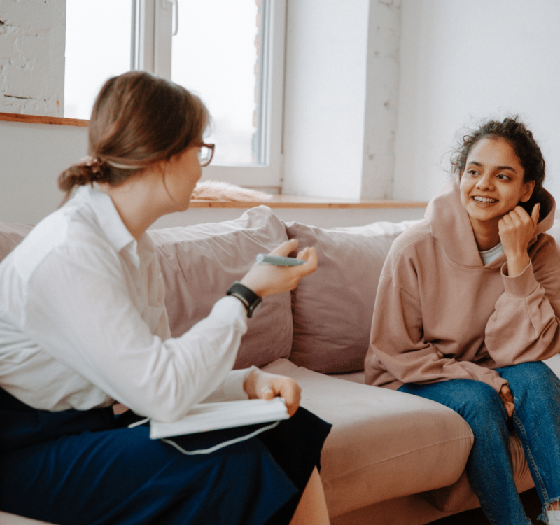 teenager speaking to her therapist about teenager playing on the computer showing signs of hyperfixation in teens