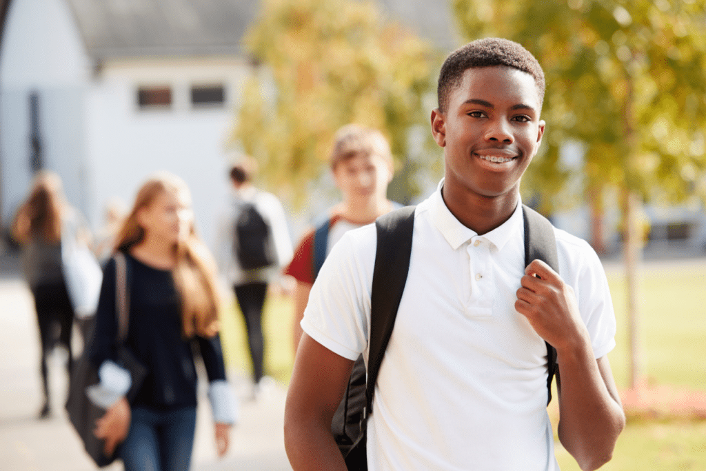 young happy teen standing outside therapeutic boarding schools