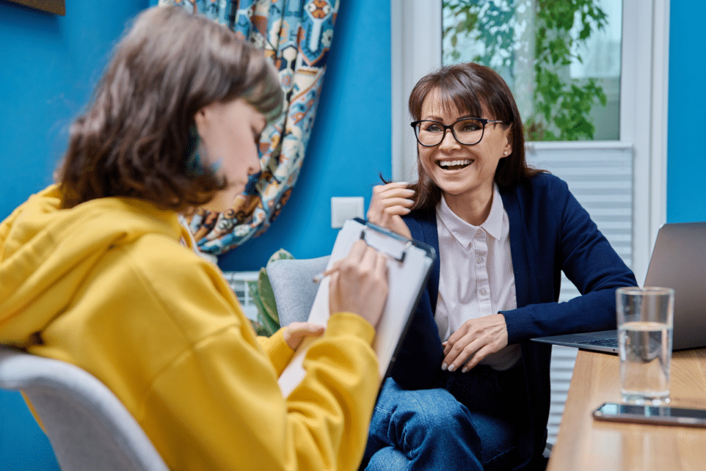 teen speaking with her therapist after parents learned the answer to will insurance cover teen residential treatment?