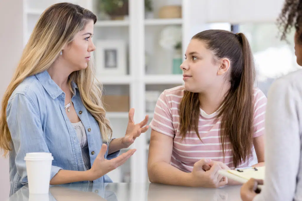 mother sitting with her daughter in family therapy discussing Are Teen Curfews Good For Mental Health?