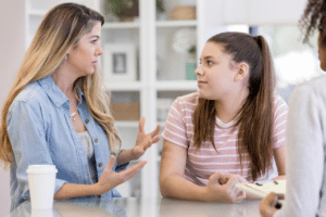 mother sitting with her daughter in family therapy discussing Are Teen Curfews Good For Mental Health?