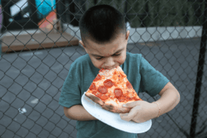 child-chewing-on-pizza