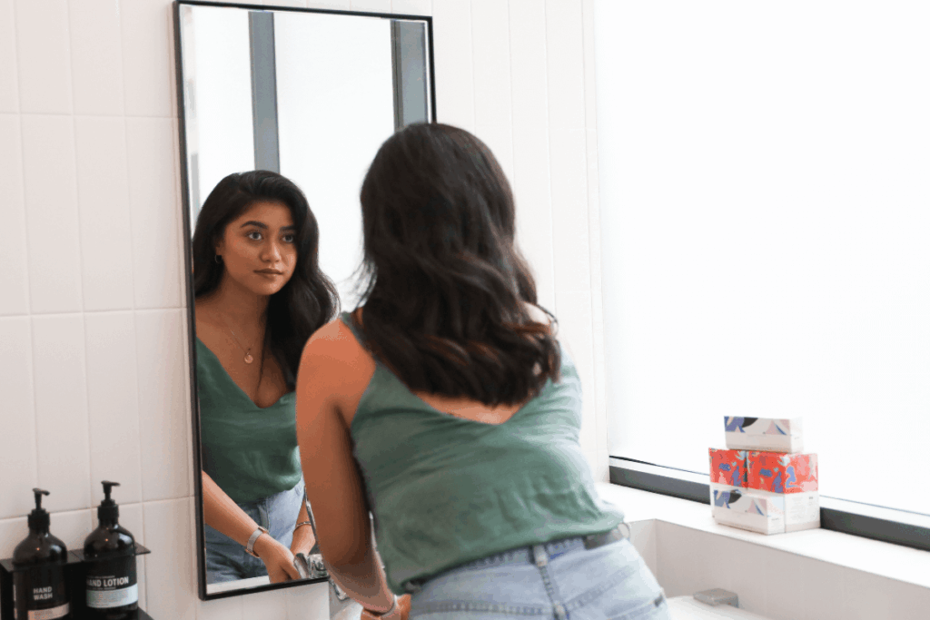 teen looking in mirror