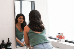 teen looking in mirror