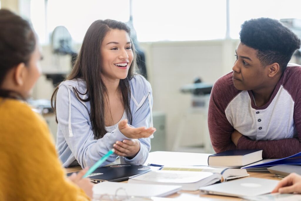 teens talking around a table